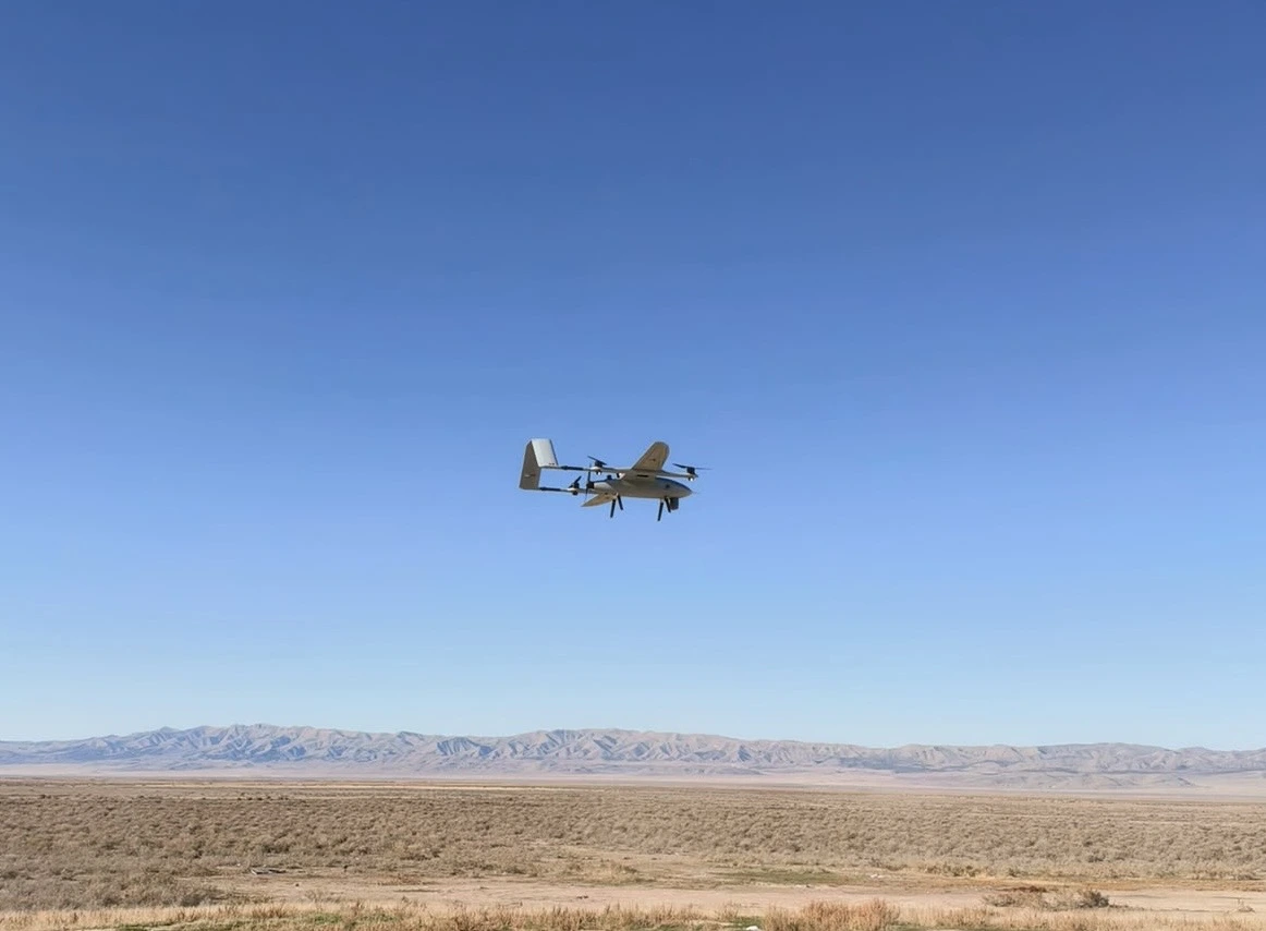 ORKID 260 VTOL flying over an open desert landscape and mountain range